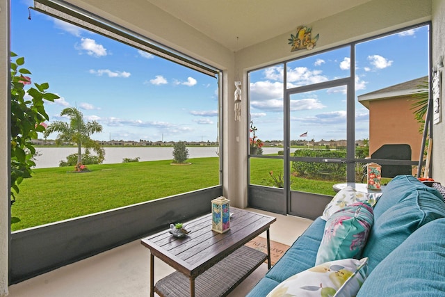 sunroom with an outdoor living space and a water view