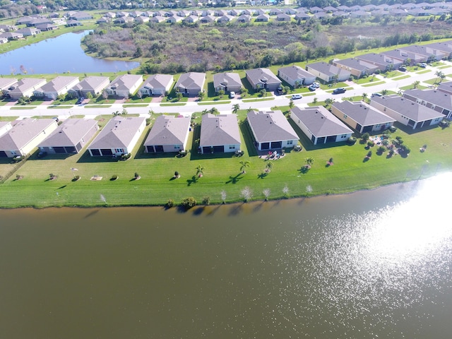 bird's eye view featuring a residential view and a water view