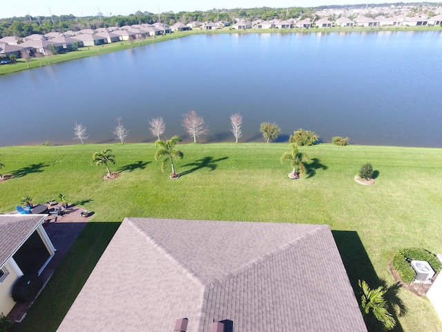 drone / aerial view featuring a residential view and a water view