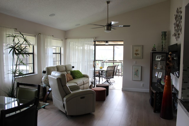 3371 Jog Park Dr, Greenacres, FL 33467 - living room with hardwood / wood-style flooring, vaulted ceiling, ceiling fan, and a textured ceiling