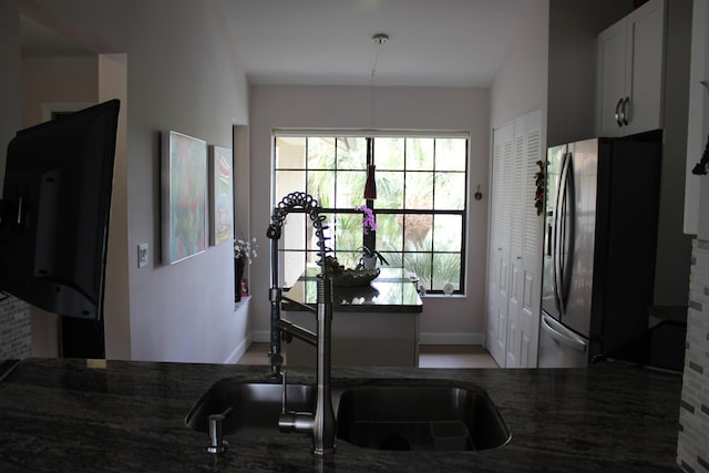 3371 Jog Park Dr, Greenacres, FL 33467 - kitchen featuring dark stone countertops, black refrigerator with ice dispenser, and white cabinets