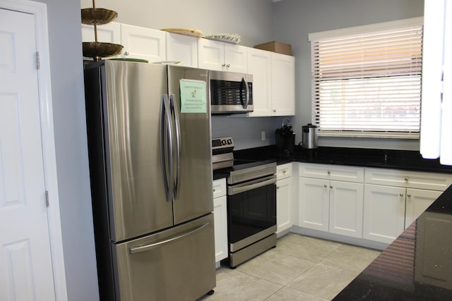3371 Jog Park Dr, Greenacres, FL 33467 - kitchen with light tile patterned flooring, appliances with stainless steel finishes, pendant lighting, dark stone counters, and white cabinets
