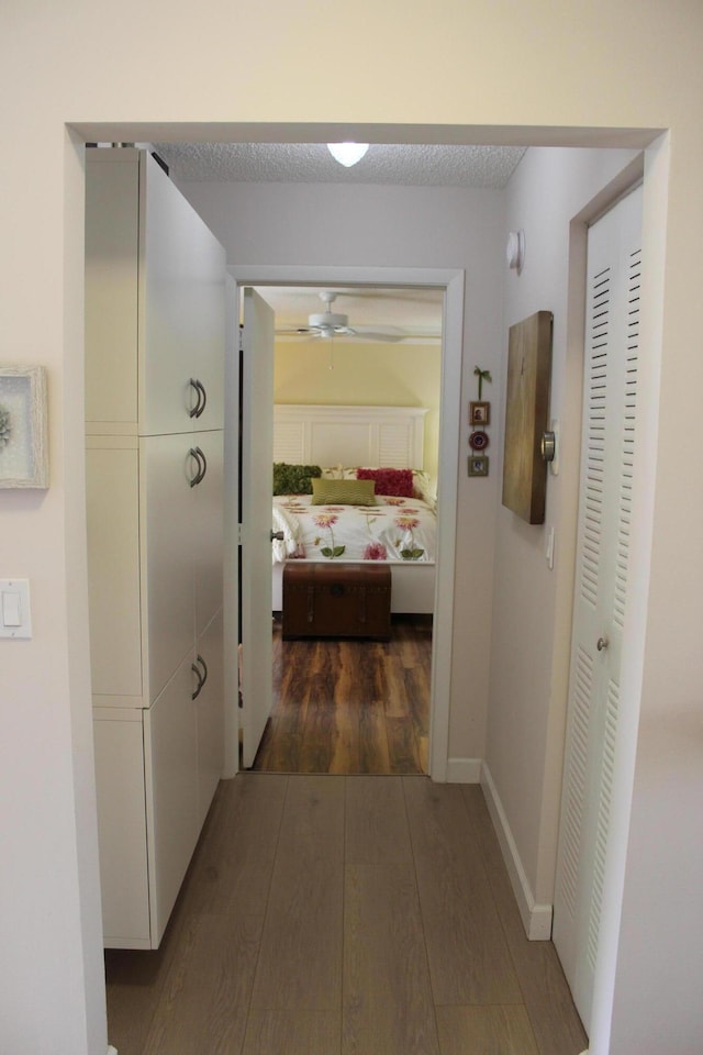 3371 Jog Park Dr, Greenacres, FL 33467 - hallway with a textured ceiling and dark hardwood / wood-style flooring