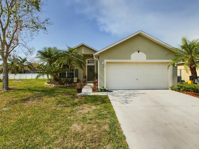 single story home featuring a garage and a front lawn