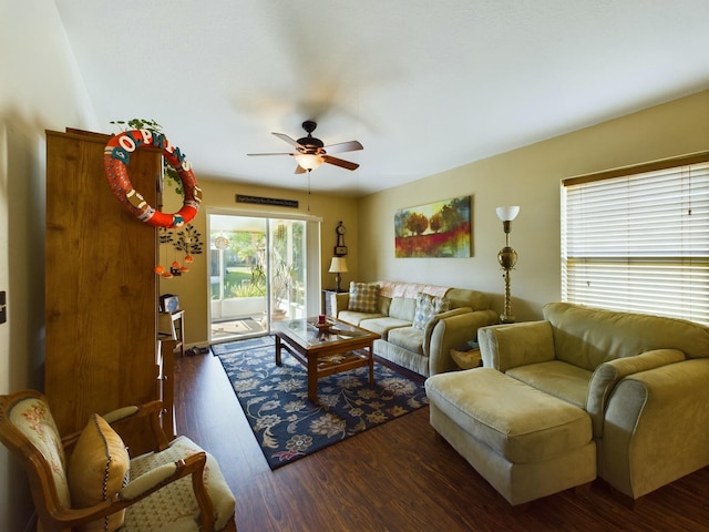 living room with dark wood-type flooring and ceiling fan