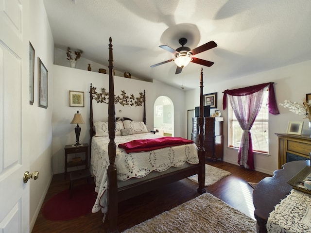 bedroom featuring dark hardwood / wood-style flooring, vaulted ceiling, and ceiling fan