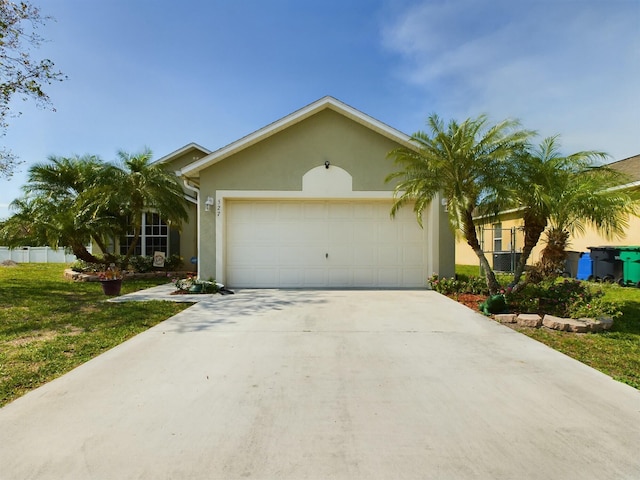 single story home with a garage and a front yard