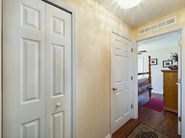 corridor with dark hardwood / wood-style floors