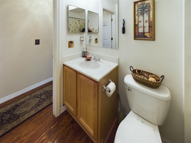 bathroom featuring vanity, wood-type flooring, and toilet