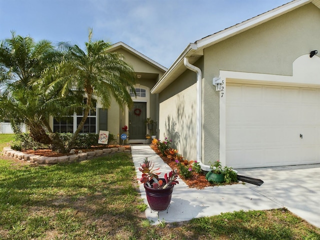 view of front of house featuring a garage and a front lawn