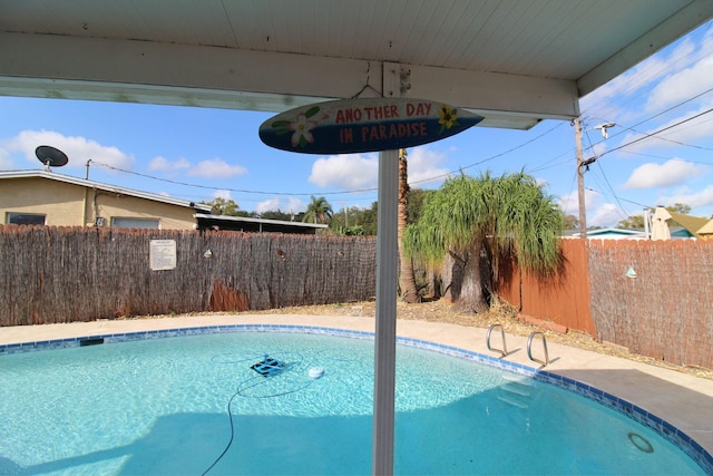 view of swimming pool with a fenced in pool and a fenced backyard