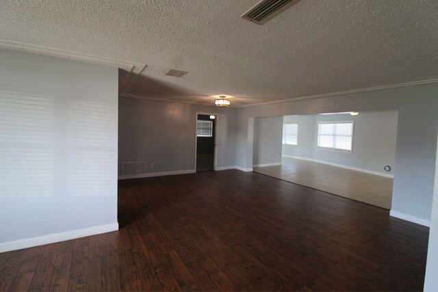 empty room with ceiling fan, dark hardwood / wood-style floors, and a textured ceiling