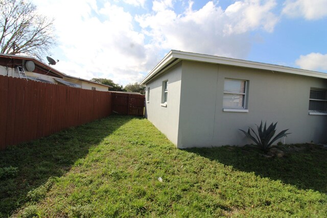 view of side of property with a yard