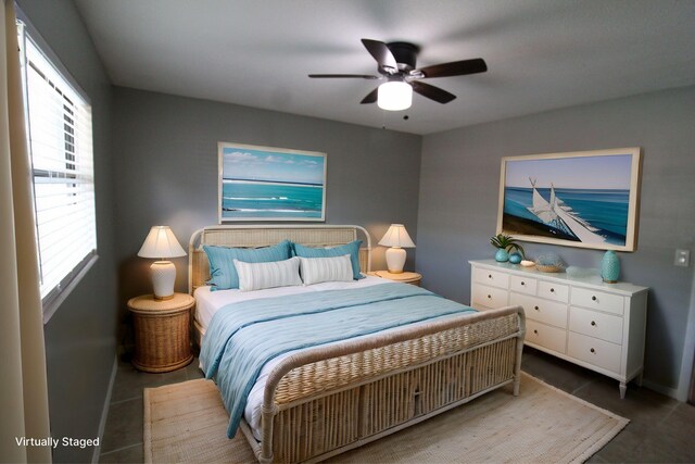 bedroom with tile patterned flooring and a ceiling fan