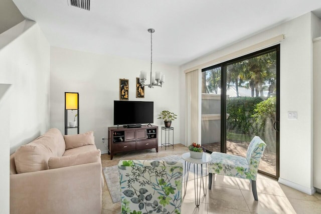 living area with an inviting chandelier, baseboards, and visible vents