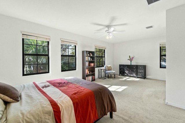 bedroom featuring a ceiling fan, baseboards, visible vents, and carpet flooring