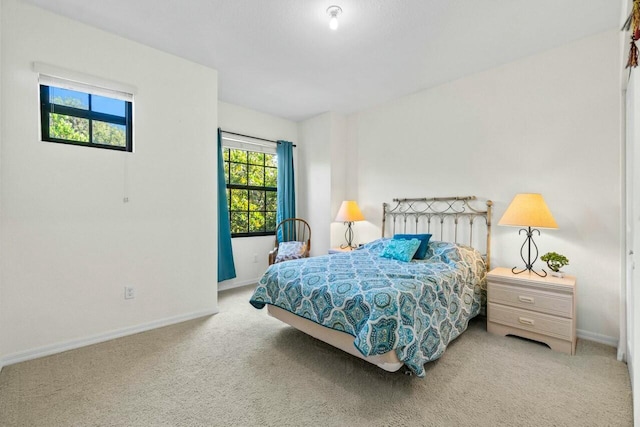 carpeted bedroom with baseboards