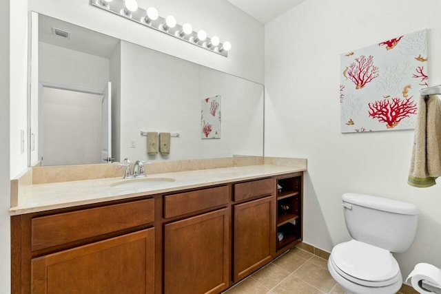 bathroom featuring toilet, tile patterned flooring, vanity, and visible vents