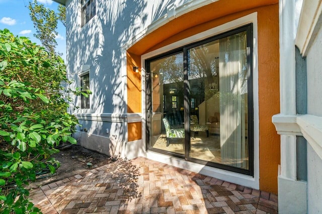 doorway to property with a patio area