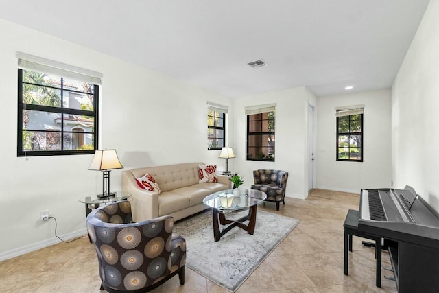 living area featuring visible vents and baseboards