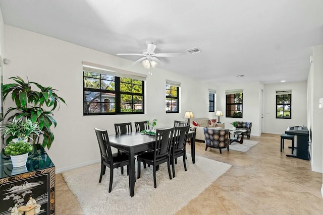 dining space featuring visible vents, ceiling fan, and baseboards