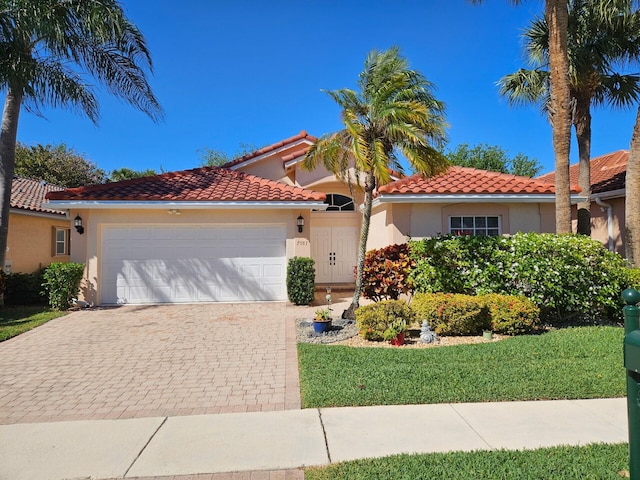 7087 Lombardy St, Boynton Beach, FL 33472 - view of front of house featuring a tile roof, decorative driveway, an attached garage, and stucco siding