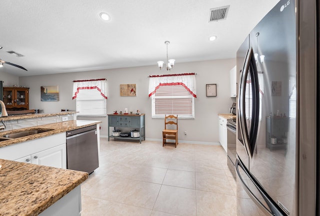 7087 Lombardy St, Boynton Beach, FL 33472 - kitchen with a sink, stainless steel appliances, visible vents, and white cabinetry