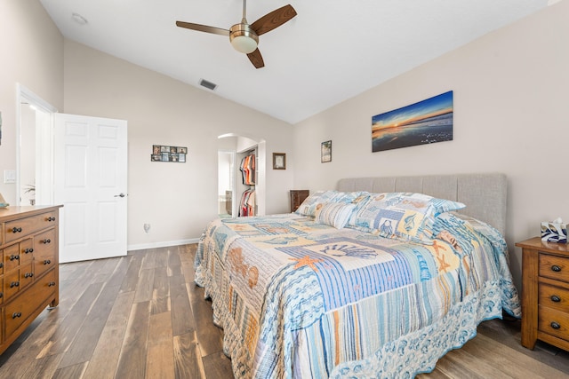 7087 Lombardy St, Boynton Beach, FL 33472 - bedroom with visible vents, a walk in closet, dark wood finished floors, arched walkways, and lofted ceiling