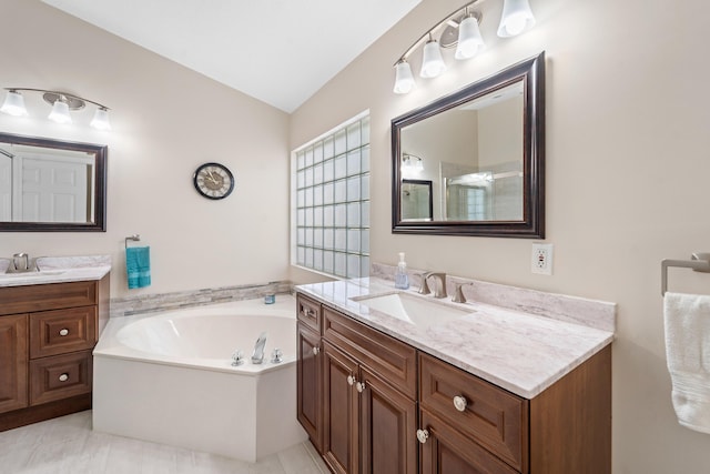 7087 Lombardy St, Boynton Beach, FL 33472 - bathroom featuring a garden tub, two vanities, lofted ceiling, and a sink