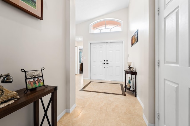 foyer entrance featuring light tile patterned floors and baseboards