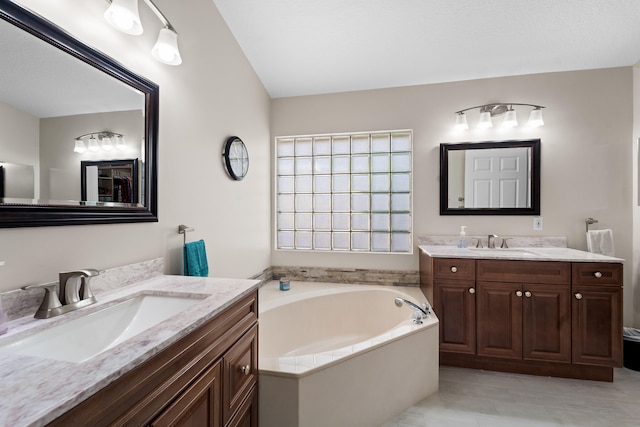 7087 Lombardy St, Boynton Beach, FL 33472 - bathroom with a garden tub, two vanities, and a sink