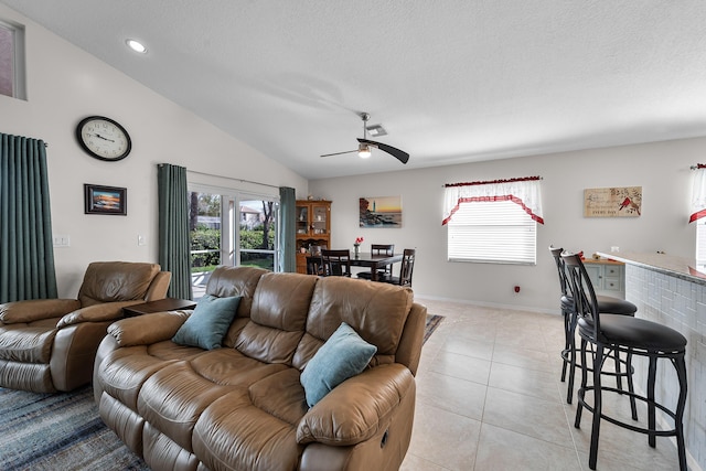 7087 Lombardy St, Boynton Beach, FL 33472 - living area featuring a textured ceiling, lofted ceiling, light tile patterned floors, and ceiling fan
