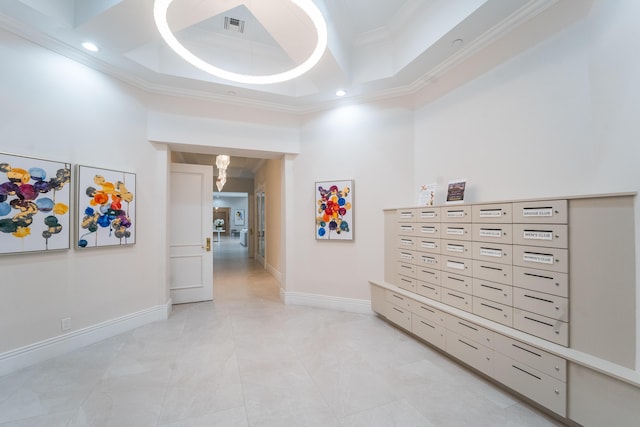 7087 Lombardy St, Boynton Beach, FL 33472 - hallway featuring baseboards, visible vents, a tray ceiling, a towering ceiling, and crown molding