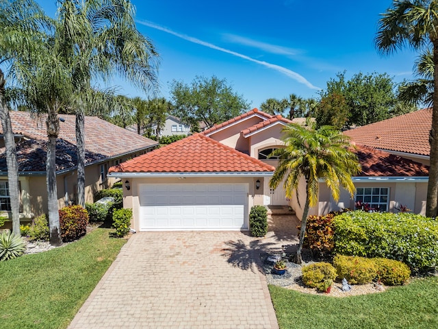7087 Lombardy St, Boynton Beach, FL 33472 - mediterranean / spanish home with a garage, a tile roof, driveway, and stucco siding