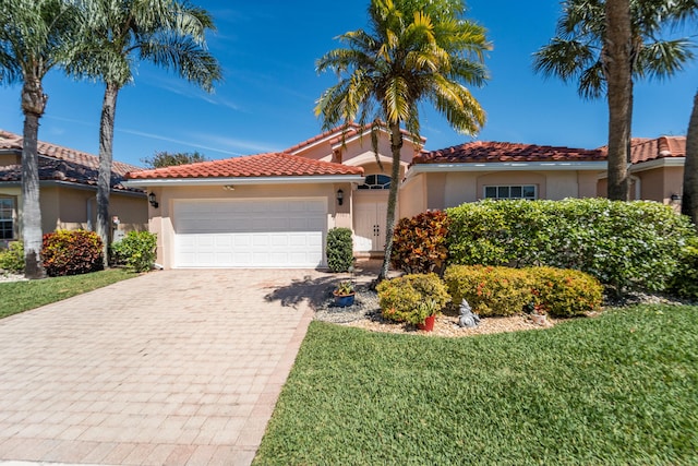 7087 Lombardy St, Boynton Beach, FL 33472 - mediterranean / spanish house with a tiled roof, a front yard, stucco siding, a garage, and driveway