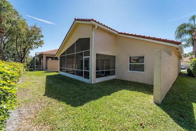 7087 Lombardy St, Boynton Beach, FL 33472 - back of property featuring stucco siding, a tiled roof, and a lawn