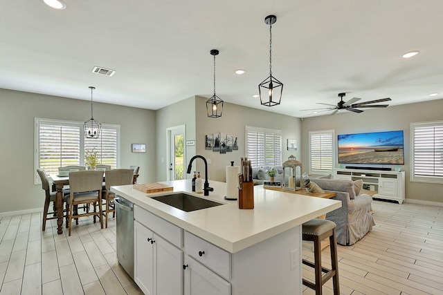 kitchen with visible vents, dishwasher, open floor plan, a sink, and recessed lighting