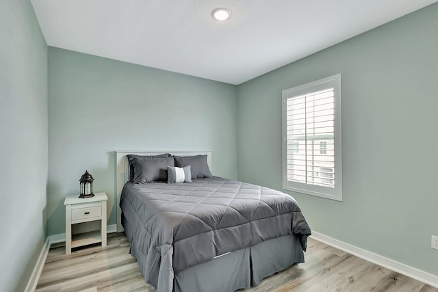 bedroom featuring baseboards and wood finished floors