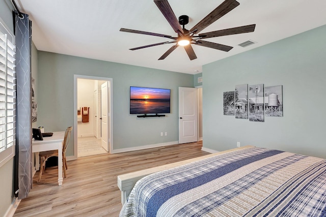 bedroom with baseboards, visible vents, ensuite bath, ceiling fan, and light wood-type flooring