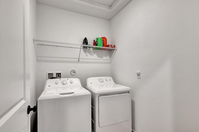 clothes washing area with laundry area and washing machine and clothes dryer