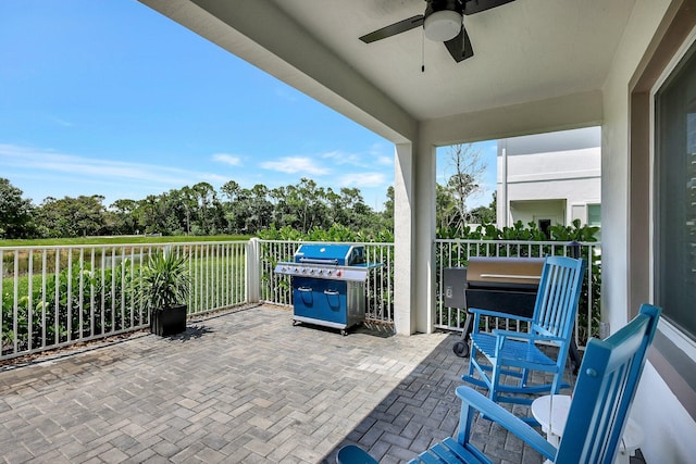 view of patio / terrace with a balcony, grilling area, and a ceiling fan