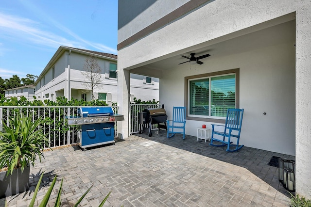 view of patio / terrace with a grill, fence, and ceiling fan