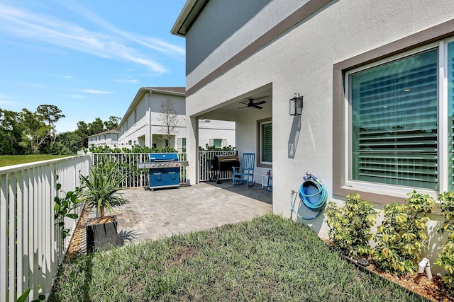 view of patio featuring area for grilling and a ceiling fan