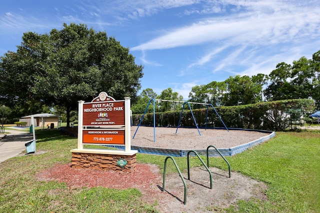 view of home's community featuring a lawn and playground community