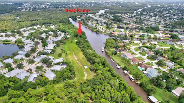 birds eye view of property with a water view and a residential view