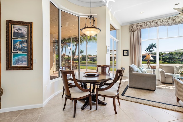 dining area featuring tile patterned flooring, baseboards, and crown molding