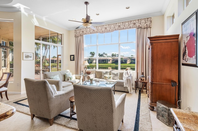 living area with a ceiling fan, light tile patterned flooring, crown molding, and baseboards