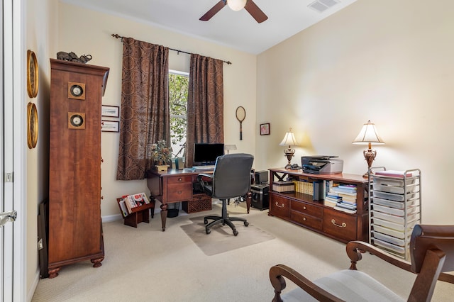 carpeted home office featuring ceiling fan, visible vents, and baseboards