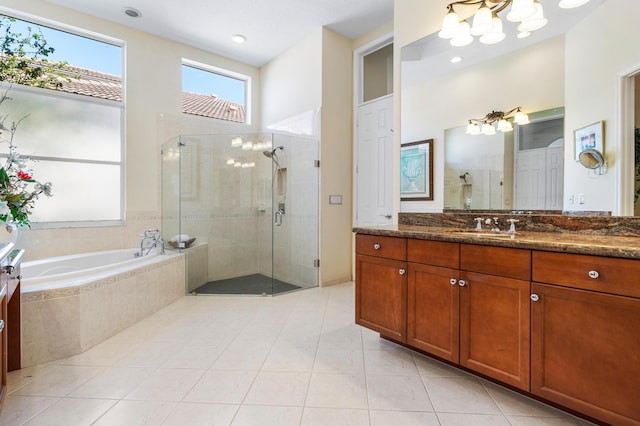 bathroom with a garden tub, tile patterned flooring, a shower stall, and vanity