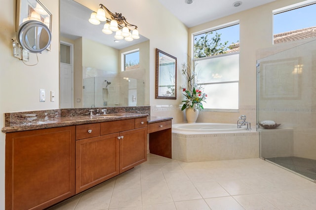 full bath featuring a stall shower, a garden tub, vanity, and tile patterned floors